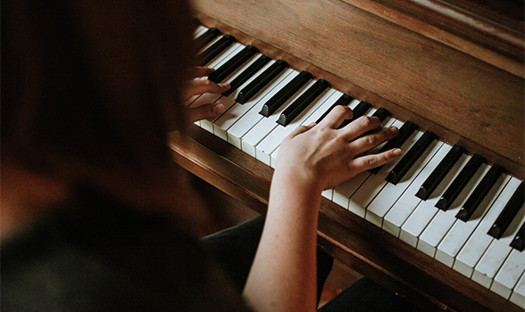 aerial shot of woman playing piano
