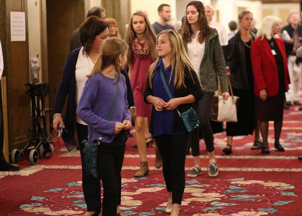 group of students and families walking in the lobby
