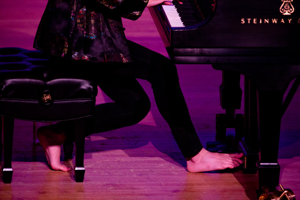 Conrad Tao wearing no shoes while performing on stage