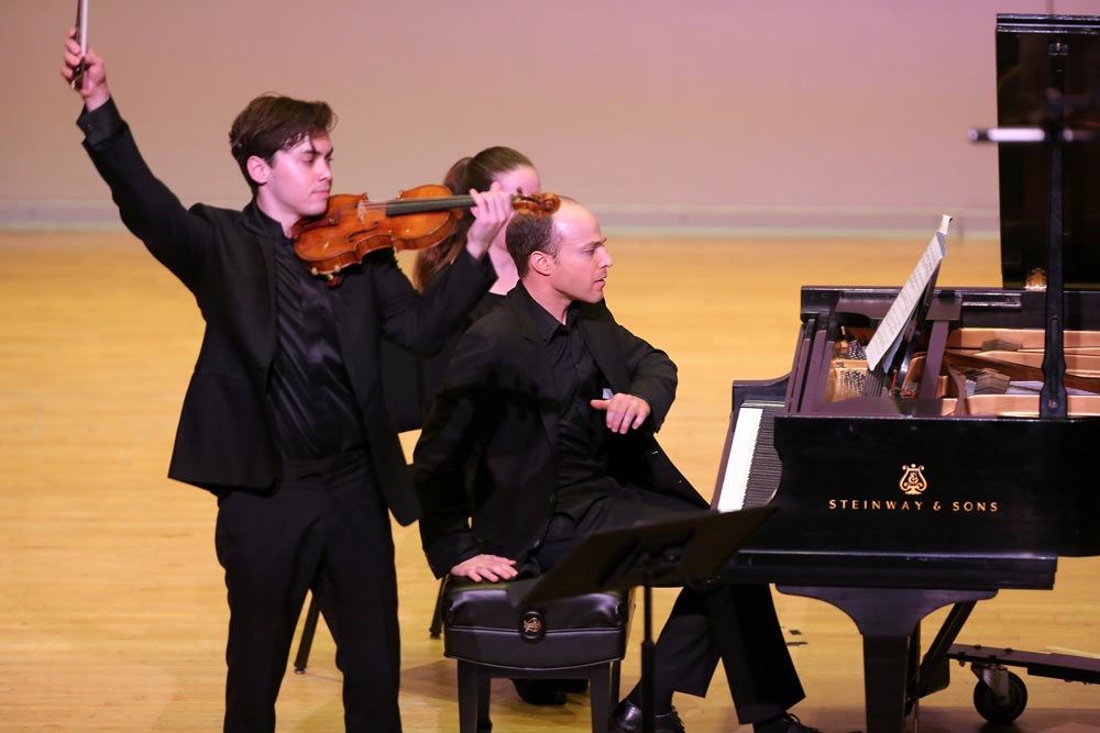 close up of Benjamin Beilman & Orion Weiss on the stage performing