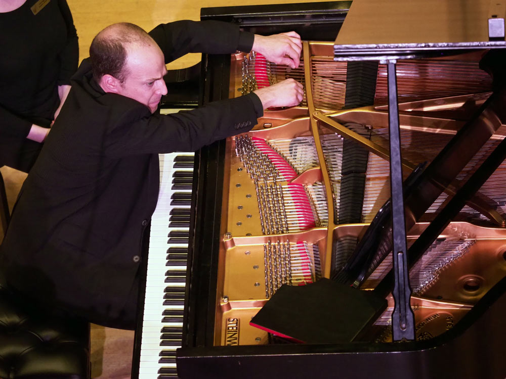Orion Weiss playing the piano on stage