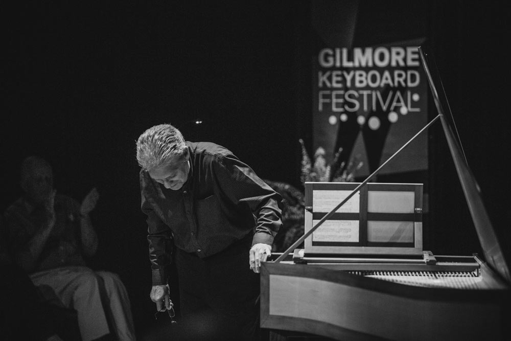 Kim Heindel bowing on stage in black and white
