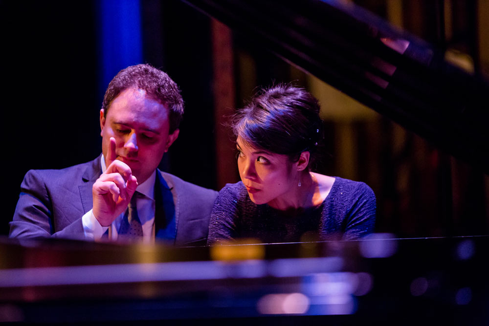 close up of Stephanie Trick & Paolo Alderighi playing the piano