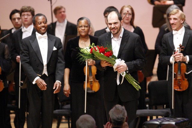 Gerstein on stage holding flowers