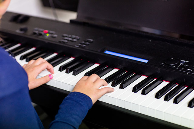 student playing on digital keyboard