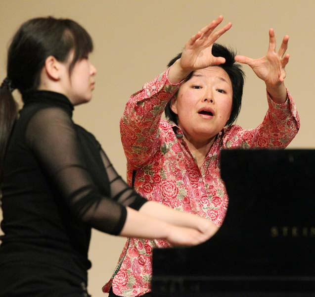Katherine Chi giving a student instruction