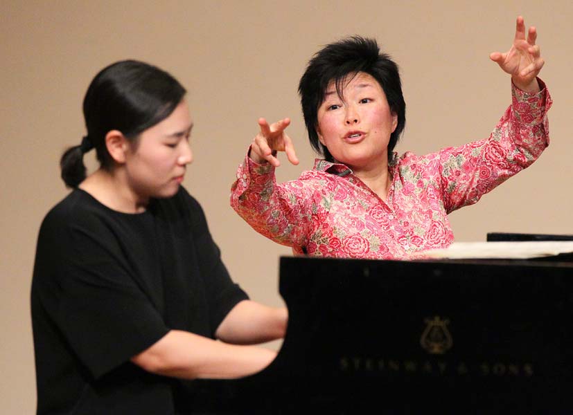 Katherine Chi instructing a student during a master class
