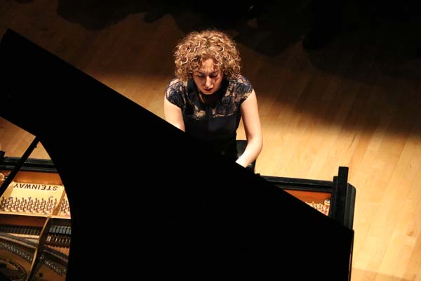 Sara Daneshpour playing piano on stage