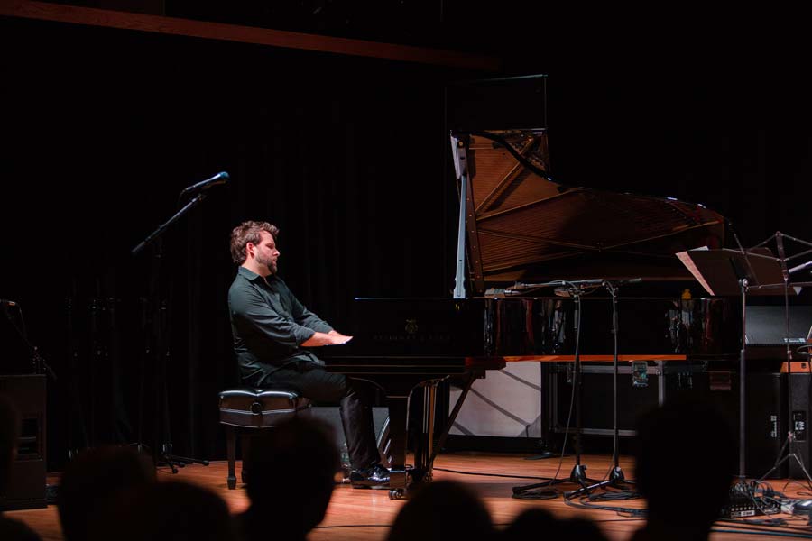 the Taylor Eigsti Trio's pianist in a spotlight on stage