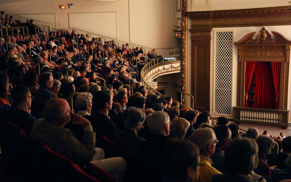 an audience looking at the stage in a theatre
