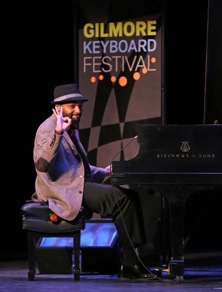the Sullivan Fortner Trio's pianist giving the audience the ok hand sign