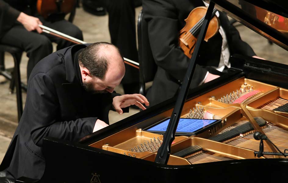 Kirill Gerstein leaned over the piano during a piece