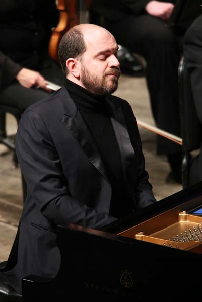 Kirill Gerstein at the piano with his eyes closed