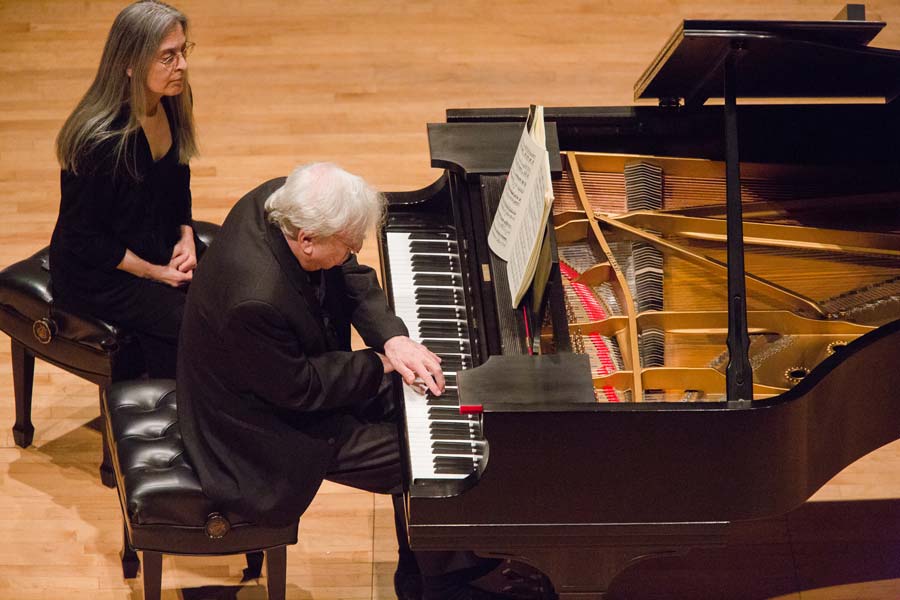 Richard Goode with his hands crossed while playing a song