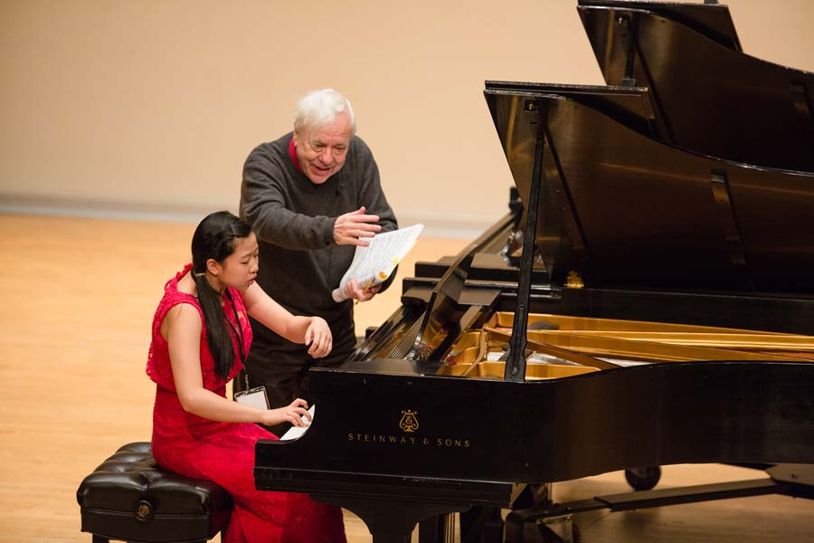 Richard Goode with one hand in the air during his class