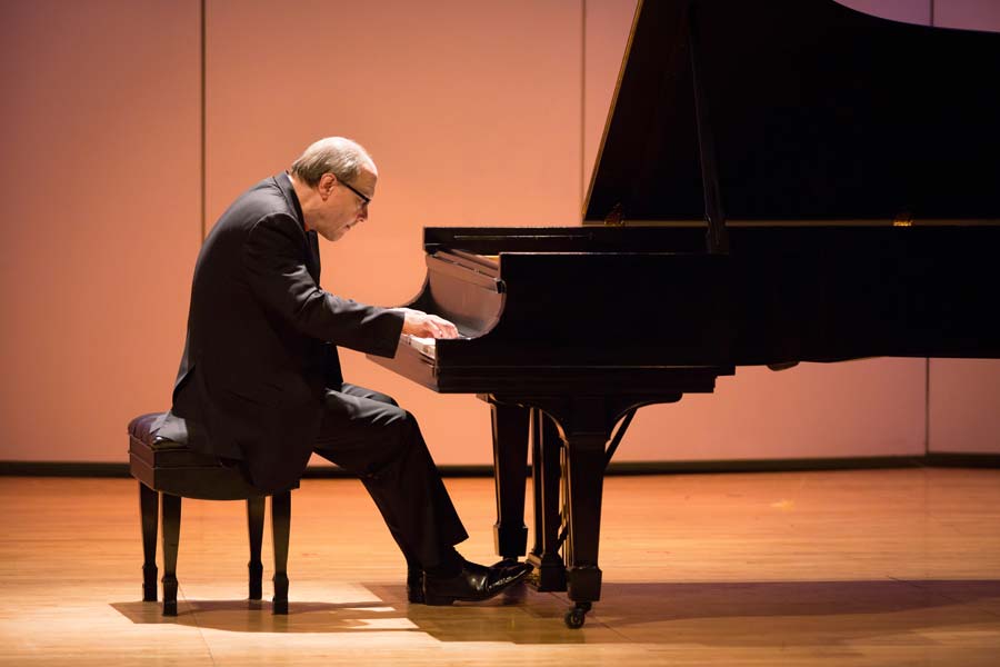 Marc-André Hamelin leaning over the piano