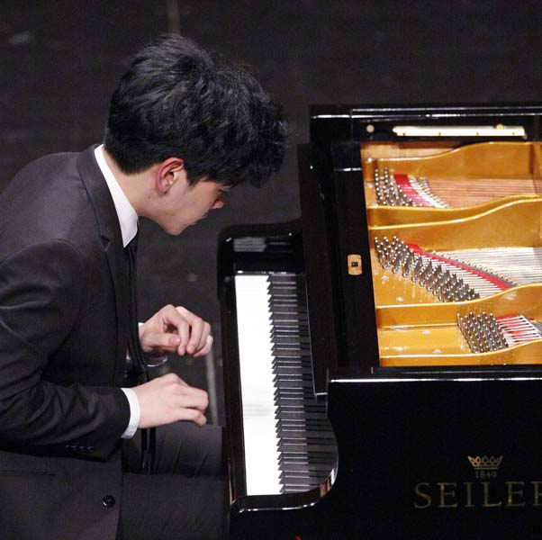 Daniel Hsu playing the piano at his performance