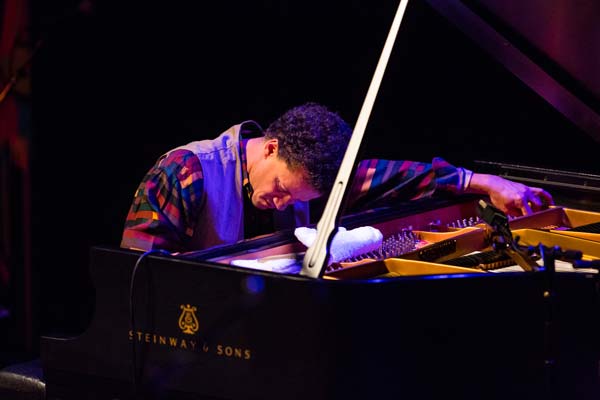 member of the Jacky Terrasson Trio leaning over the piano