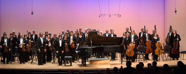 Rafal Blechacz standing with the orchestra