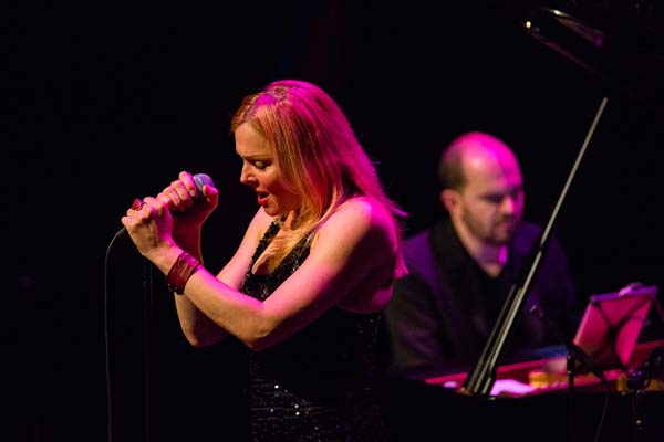 Storm Large with her hands on the microphone