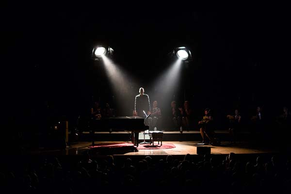John Legend silhouette on stage