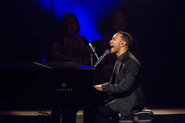 John Legend singing into the microphone