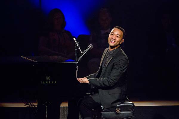 John Legend smiling at the audience