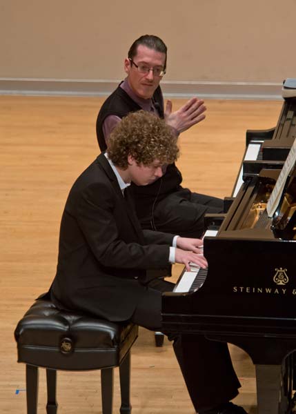 Llyr Williams listening to student play the piano