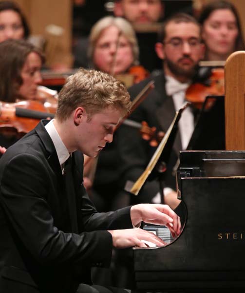 Micah McLaurin playing a steinway with the orchestra