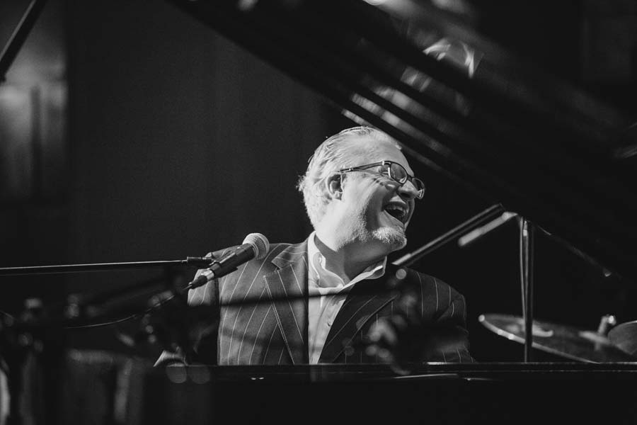 the Mr. B Trio's pianist smiling in black and white