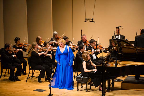 orchestra performing with singer in blue dress
