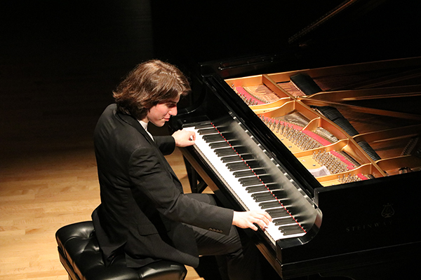Llewellyn Sanchez-Werner playing piano on stage