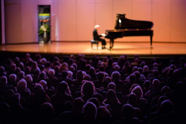 Sir András Schiff on stage playing piano