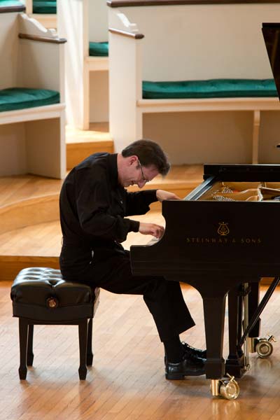 Llyr Williams hunched over playing the piano