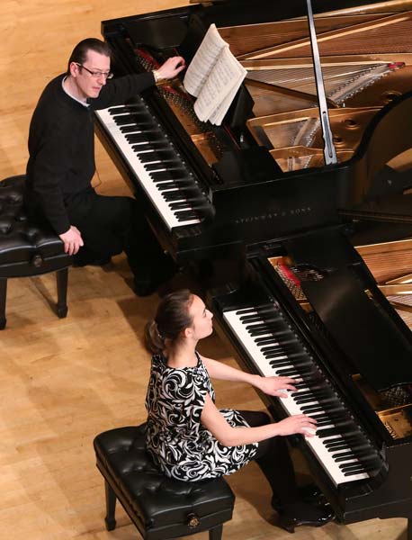 Llŷr Williams at a piano alongside his student