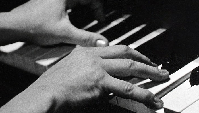 woman's hands playing the piano