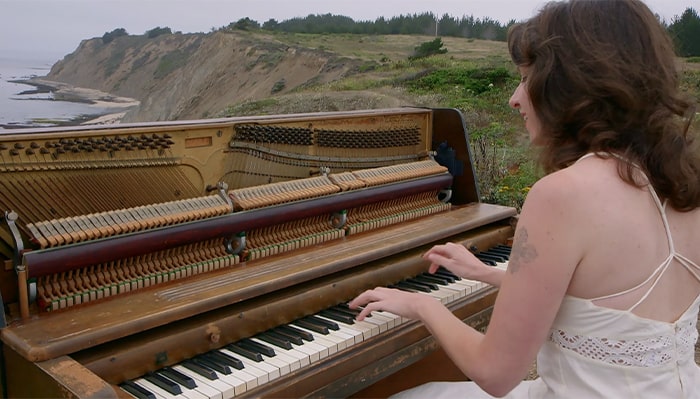 woman playing piano outdoors