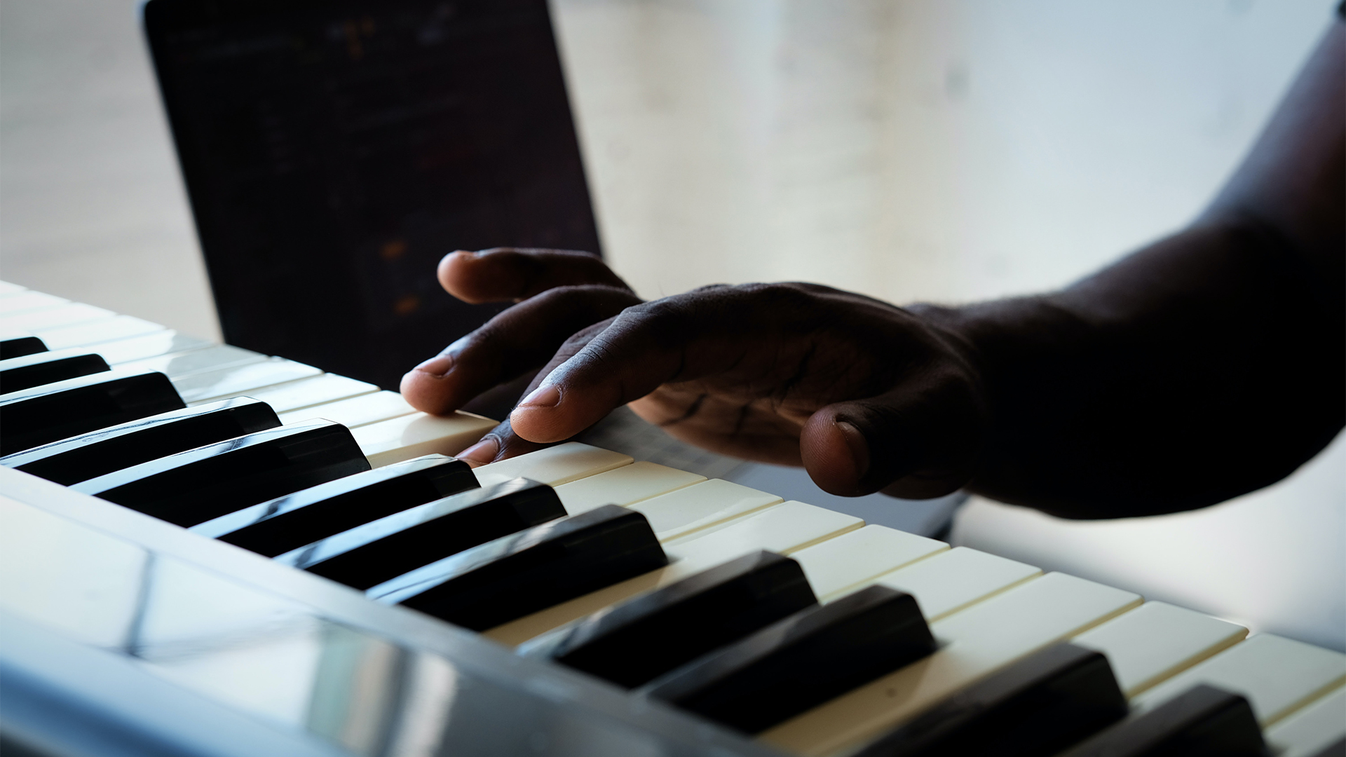 persons hand playing the piano