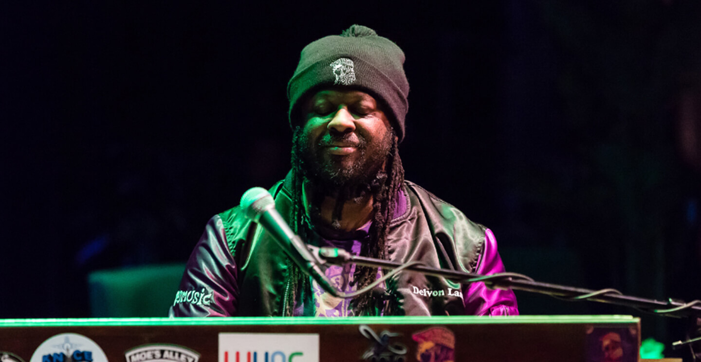 Delvon Lamarr smiles while playing piano