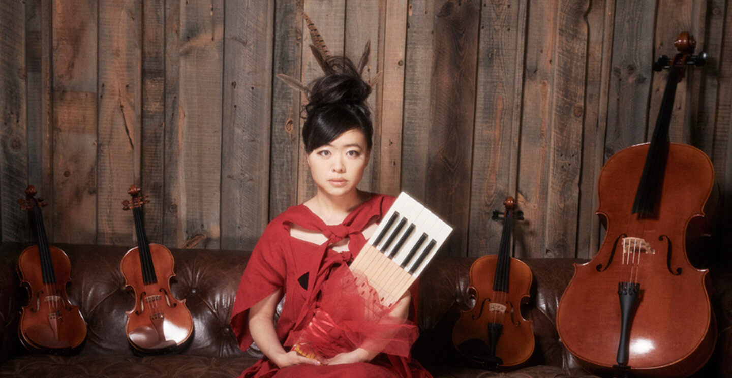 Hiromi poses for a portrait with musical instruments