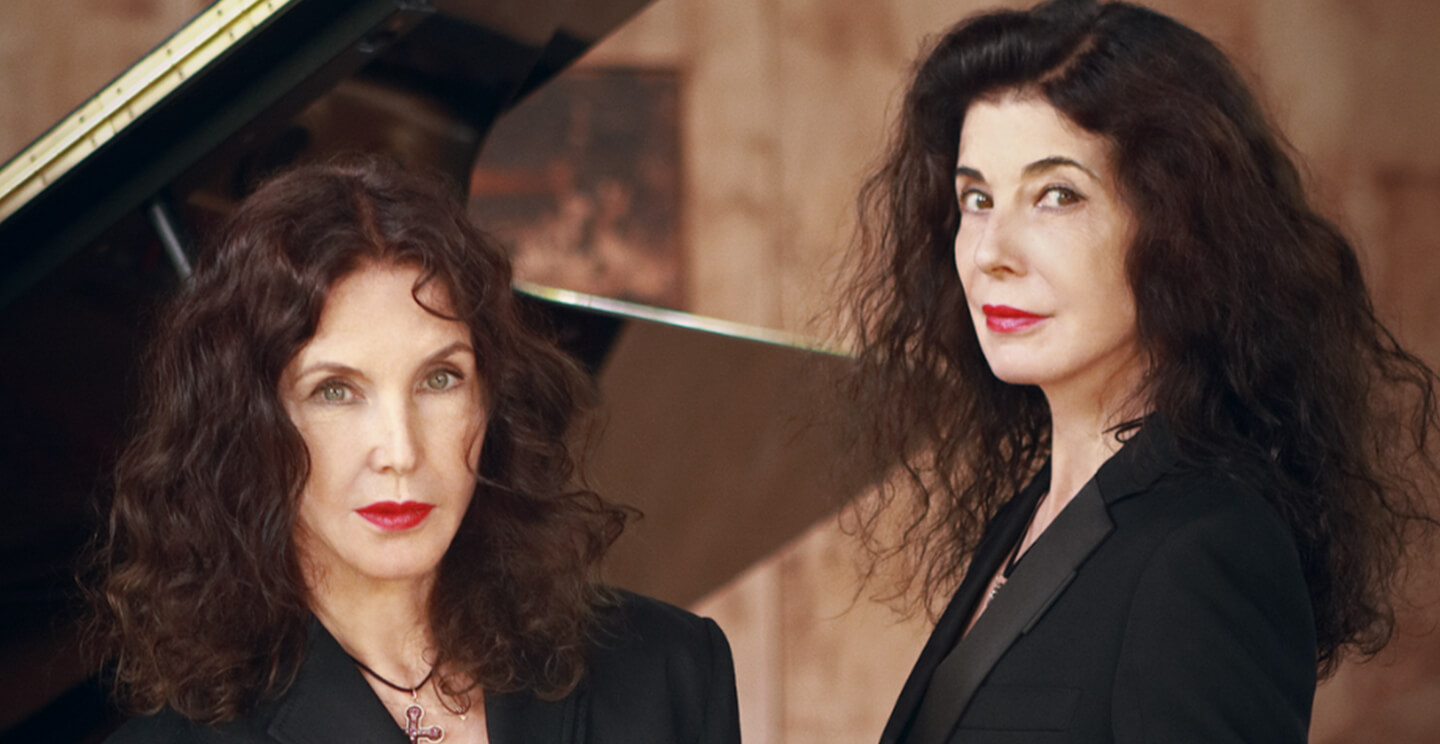 French sisters Katia and Marielle Labèque pose for a portrait in front of a piano