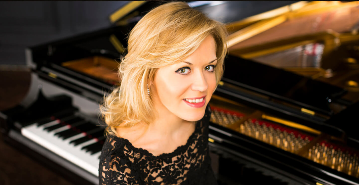 olga kern smiles in front of a piano