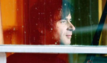 Piotr Anderszewski looks out through a window